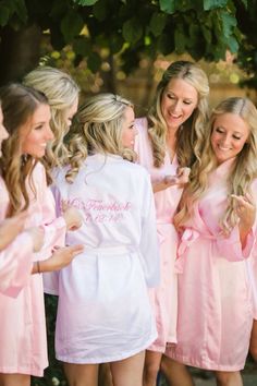 a group of women in pink robes standing next to each other