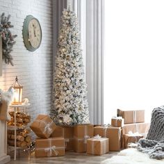 a living room decorated for christmas with presents under the tree and a clock on the wall