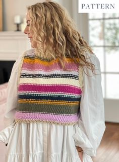 a woman wearing a multicolored knitted vest with ruffles on the back