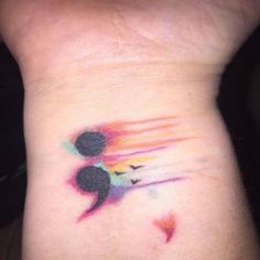 a person with a colorful tattoo on their wrist