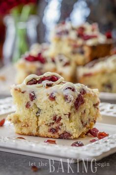 a close up of a piece of cake on a plate with cranberry topping