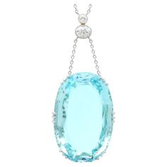 A stunning, fine and impressive, large 48.34 carat aquamarine and 0.70cttw diamond, platinum and 18 karat yellow gold necklace; part of our diverse aquamarine jewelry collections. This magnificent, fine and impressive pendant has been crafted in platinum and 18k yellow gold. The drop style pendant is ornamented with a stunning and large vintage (circa 1940) claw set 48.34ct cushion cut aquamarine; the nature of the aquamarine cut allows the piece to sit flush in situ, this is a fine feature of the piece. The feature platinum setting suspends via two chains from a yellow gold and platinum set vertical linear antique (circa 1900) diamond arrangement. This array is comprised of an impressive millegrain decorated collet set 0.53ct Old European oval cut diamond, surmounted with a collet set 0.1 Platinum Chain, 18k Gold Necklace, Aquamarine Pendant, Yellow Gold Necklace, Aquamarine Jewelry, Diamond Settings, Oval Cut Diamond, Round Cut Diamond, Cushion Cut