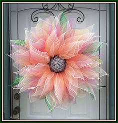 an orange and pink flower is on the front door