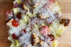 a pizza covered in toppings sitting on top of a wooden table