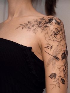 a woman with a flower tattoo on her shoulder