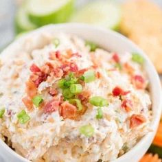 a white bowl filled with potato salad next to crackers