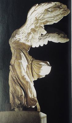 an angel statue is shown against a black background