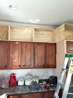 a kitchen with wooden cabinets and a ladder