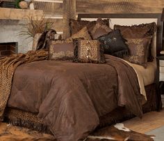 a bed with brown and tan comforters in a bedroom