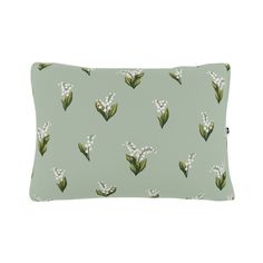 a green pillow with white flowers on it