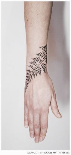 a person's hand with a tattoo on it