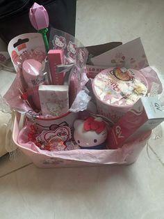 a pink hello kitty gift basket filled with items