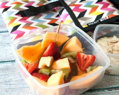 two plastic containers filled with fruit on top of a table