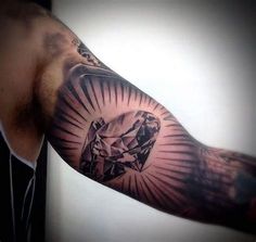 a man's arm with a diamond tattoo on it