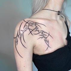 a woman with a tattoo on her shoulder