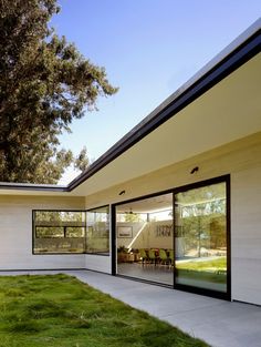 the exterior of a modern house with large windows