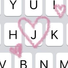 a keyboard with pink crayon letters and a heart drawn on the keypad