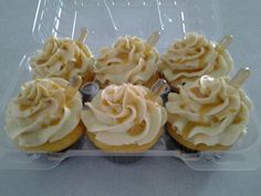 cupcakes with white frosting in a plastic container