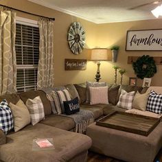 a living room filled with lots of furniture next to a wall mounted clock and window