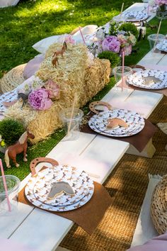 a table set up with hay bales and plates