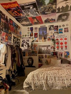 a bedroom with posters on the wall and bed