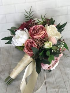 a bridal bouquet with pink and white flowers