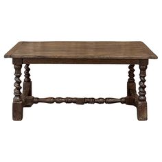 an old wooden table with turned legs and wood grained finish on the top, isolated against a white background