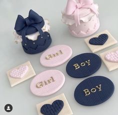 several small buttons with the words girl, boy and heart on them next to a cupcake