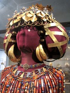 a woman's head is covered in beads and other jewelry