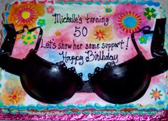 a birthday cake with two black bras on it