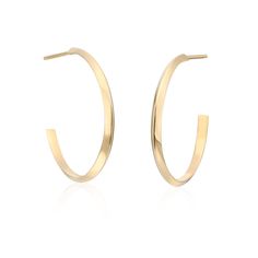 This "Edgy" take on a classic hoop is an easy way to add a little flash to your daily routine. These medium-size 20mm hoops are solid yet light-weight making them super comfortable. The knife-edge design gives them a trendy yet timeless look that will be with you forever. These earrings are offered in solid 14k Yellow Gold or Sterling Silver. The Sterling Silver option includes 14k gold posts and backs for durability. *also available in a larger 40mm version Minimalistic Jewelry, Mini Studs, Heart Women, Fine Jewelry Designers, Edge Design, Jewelry Cleaner, Bridal Gifts, Selling Jewelry, Gold Hoop