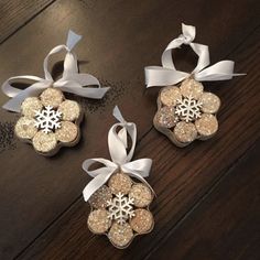 three ornaments with bows and snowflakes on them