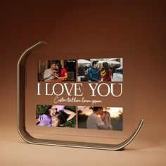 a glass photo frame with the words i love you on it and pictures of people