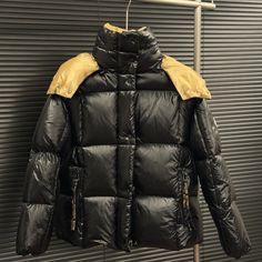 Essential Warm Clothes For Winter Luxury Black Puffer Jacket With Detachable Hood, Luxury Black Down Puffer Jacket, Designer Black Puffer Outerwear, Designer Black Winter Outerwear, Luxury Black Puffer Outerwear, Designer Black Outerwear With Padded Collar, Black Luxury Outdoor Outerwear, Classic Black Winter Puffer Jacket, Designer Black Outerwear For Outdoor