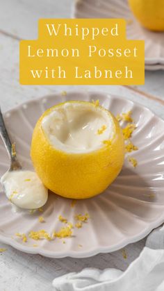 a white plate topped with lemons and yogurt next to a spoon on a table