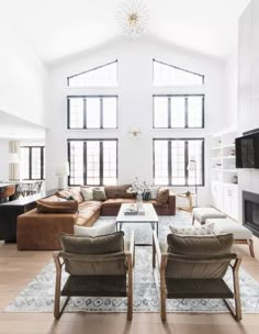 a living room filled with furniture and windows