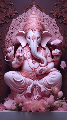 an elephant statue sitting on top of a table next to pink flowers and other decorations