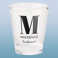 a shot glass with the words mackenzie bridesmaid printed on it, against a blue background