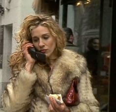 a woman talking on a cell phone while walking down the street