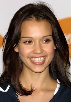 a smiling young woman with long brown hair