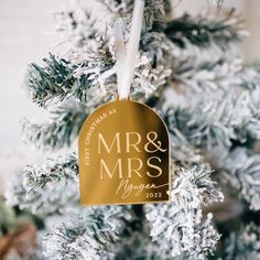 an ornament hanging from a christmas tree that says mr and mrs on it