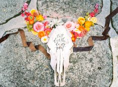 an animal skull with flowers on it's head and the words still do us part