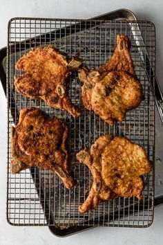 four pieces of chicken on a cooling rack