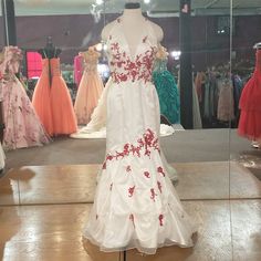 Halter Top Red Floral Designs Scattered Through The Dress With A Mermaid Cut And Subtle Rouging At The Skirt. White Prom, Prom Dress Color, White Prom Dress, A Mermaid, Floral Designs, Red Floral, Halter Top, Lady In Red, Prom Dress