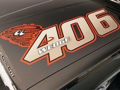 the number four on the hood of a black car with an orange and white logo