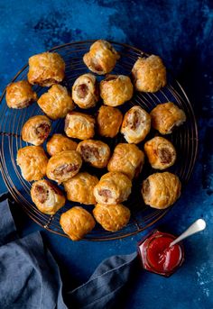 small pastries on a wire rack next to ketchup