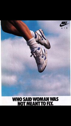 an advertisement for nike is shown in the air with someone's feet dangling off it