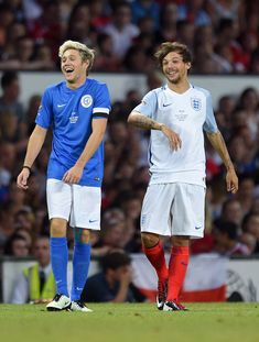 two soccer players are standing on the field