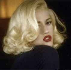 a woman with blonde hair and red lipstick