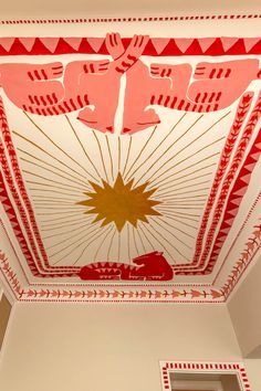 the ceiling is decorated with red and white designs, including an image of a sunburst